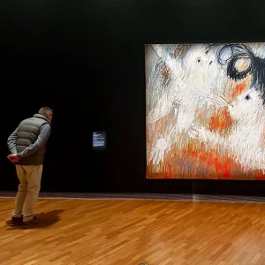 A visitor viewing an Arthur Boyd tapestry in the National Gallery of Australia in Canberra
